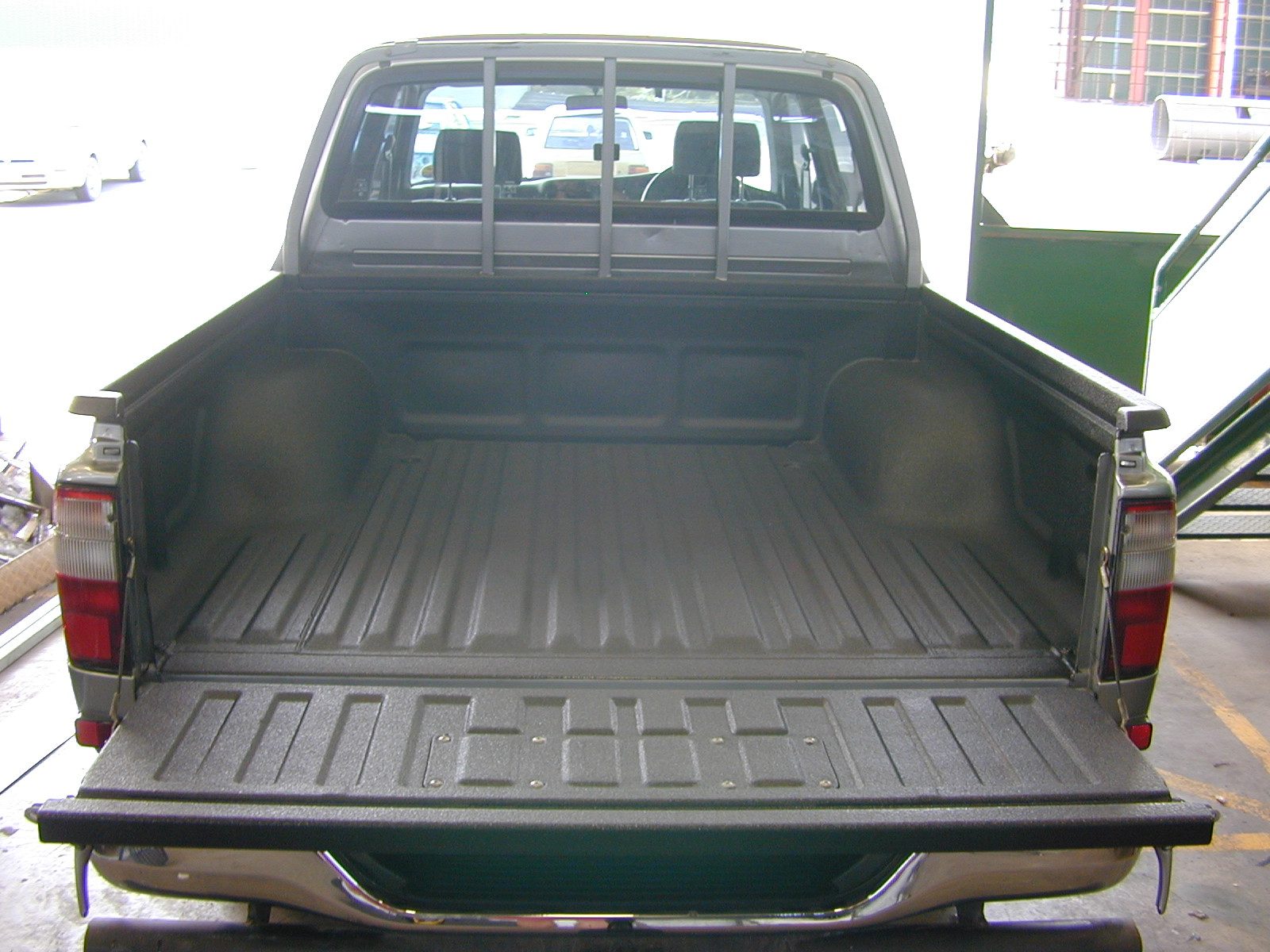 Trailer steel coated with polyurea to resist salt corrosion